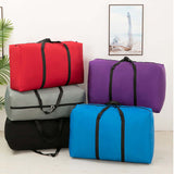 Colorful collection of 100L large foldable travel duffel bags in red, purple, grey, black, and blue.