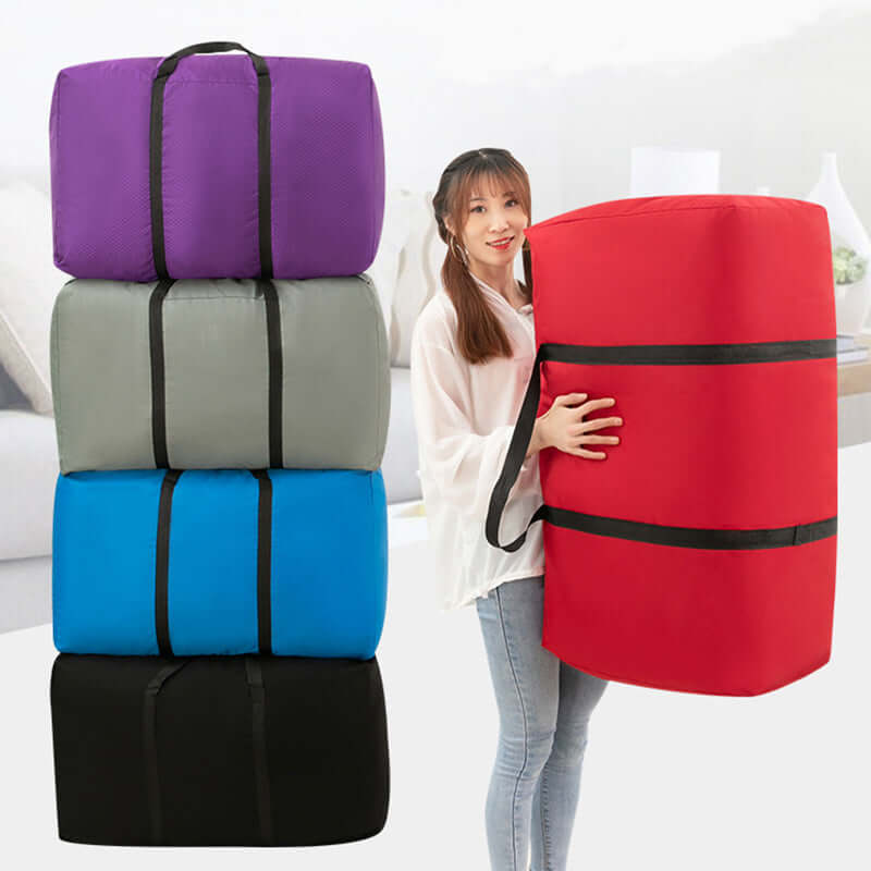 Woman carrying a large red 100L foldable travel duffel bag with colorful stacked bags in background.