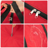 Close-up of a red foldable travel duffel bag showcasing zippers and water-resistant fabric details.