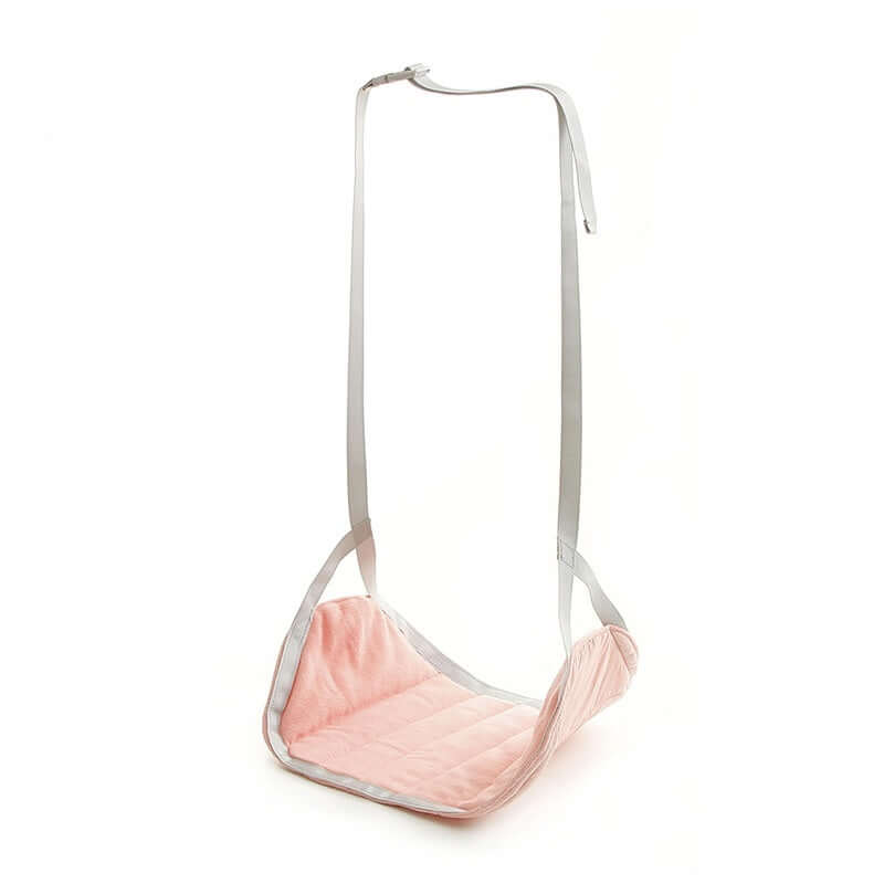 Portable travel footrest in pink with adjustable straps for comfort during flights or long journeys.