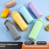 Colorful silicone foldable water bottles arranged with fruit, ideal for travel and daily hydration.