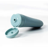 Light blue reusable travel toiletry bottle with a flip-open cap for easy filling and use.